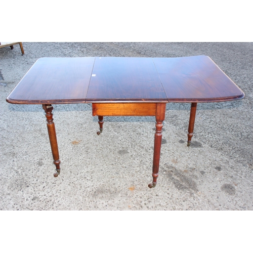 150 - An antique dropleaf mahogany table with turned legs and brass and ceramic castors, approx 147cm/ 49c... 