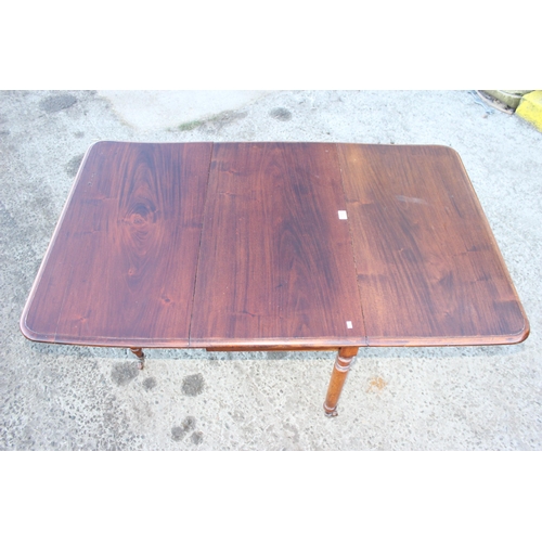 150 - An antique dropleaf mahogany table with turned legs and brass and ceramic castors, approx 147cm/ 49c... 