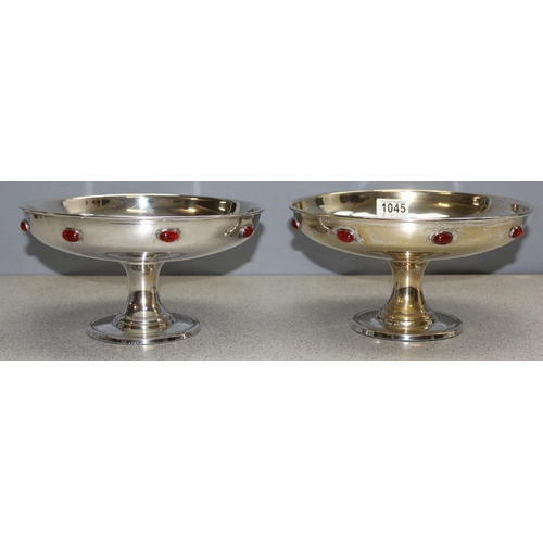 1045 - In the manner of Liberty, a pair of Arts and Crafts period silver plated comports or tazzas with cab... 