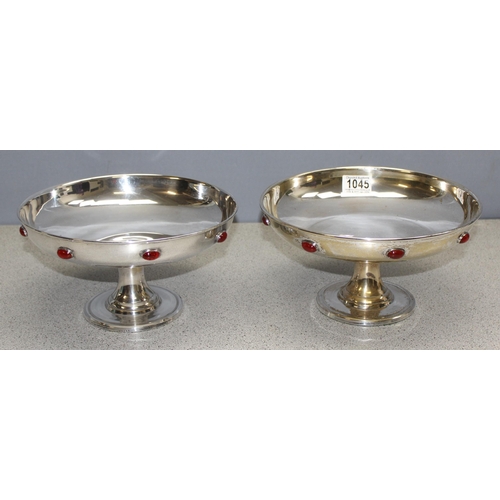 1045 - In the manner of Liberty, a pair of Arts and Crafts period silver plated comports or tazzas with cab... 