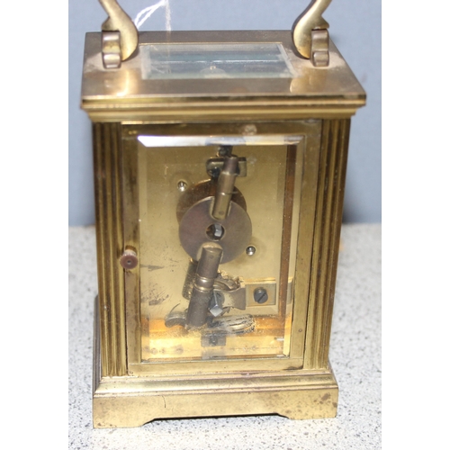 1328 - French made brass cased carriage clock with enamelled dial, key present