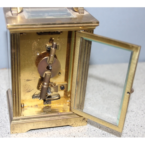 1328 - French made brass cased carriage clock with enamelled dial, key present