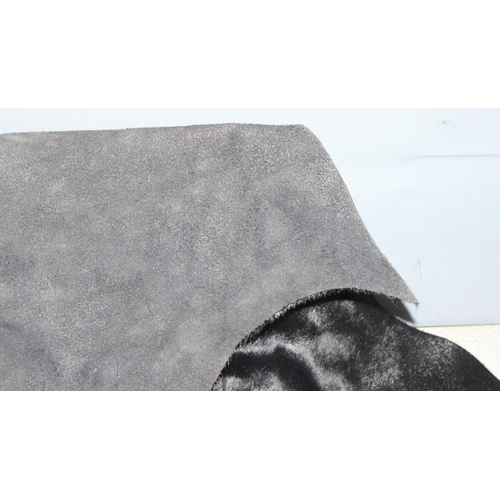 214 - Black bovine hide, approx 120cm x 80cm at widest points