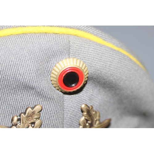 1423 - A Post-WW2 period German military cap by Bamberger, size 58, with crossed swords badge and yellow pi... 