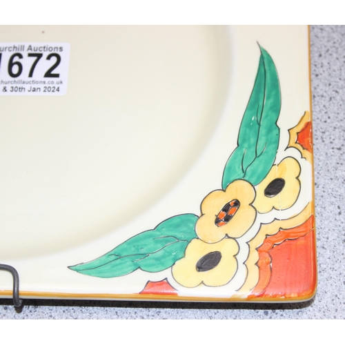 1672 - Clarice Cliff, a rare Biarritz pattern square plate decorated with flowers and wicker handle and a C... 