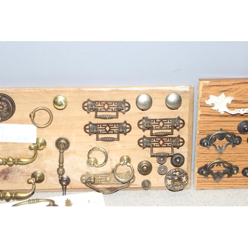 829 - Qty of assorted drawer handles mounted on boards (4)