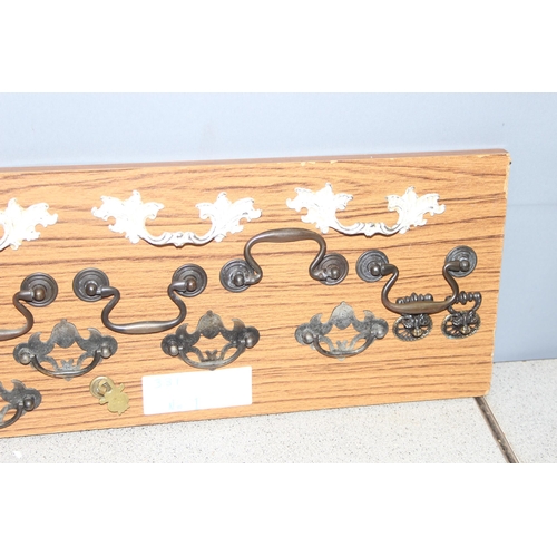 829 - Qty of assorted drawer handles mounted on boards (4)