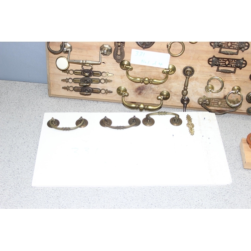 829 - Qty of assorted drawer handles mounted on boards (4)