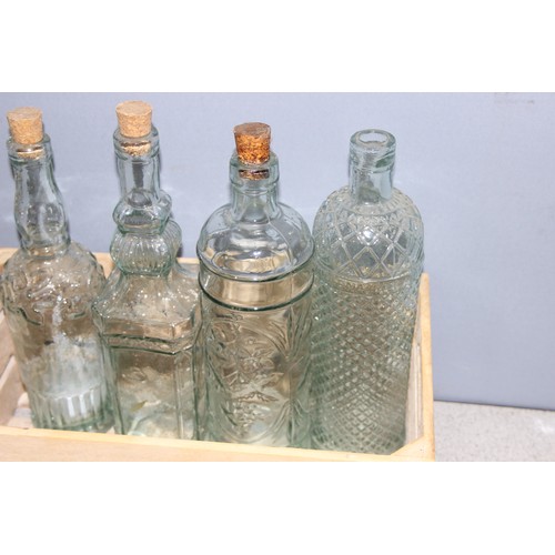 1705 - Small wooden crate with 4 decorative glass bottles with corks