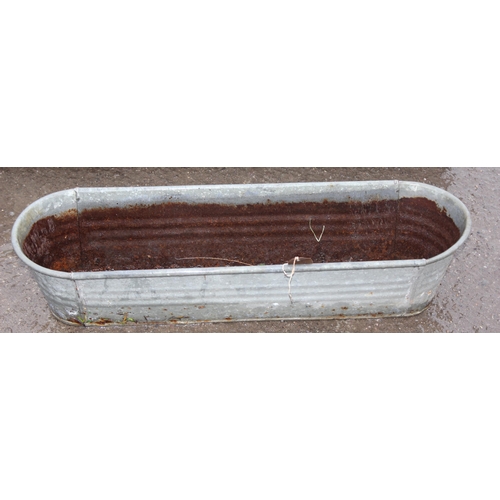 307 - 2 galvanised planters, the largest approx 94cm wide