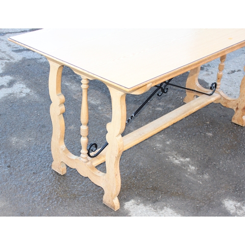 42 - An unusual light oak dining table with decorative wrought ironwork to base and matching Formica top,... 