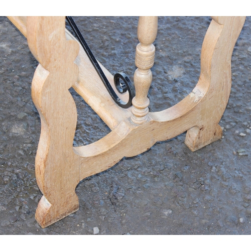 42 - An unusual light oak dining table with decorative wrought ironwork to base and matching Formica top,... 