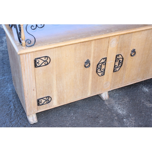 41 - An unusual carved light oak sideboard or buffet stand with 3 drawers above 2 cupboards, the piece wi... 