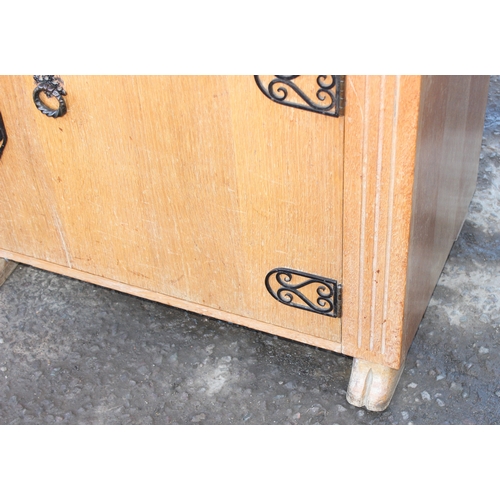 41 - An unusual carved light oak sideboard or buffet stand with 3 drawers above 2 cupboards, the piece wi... 