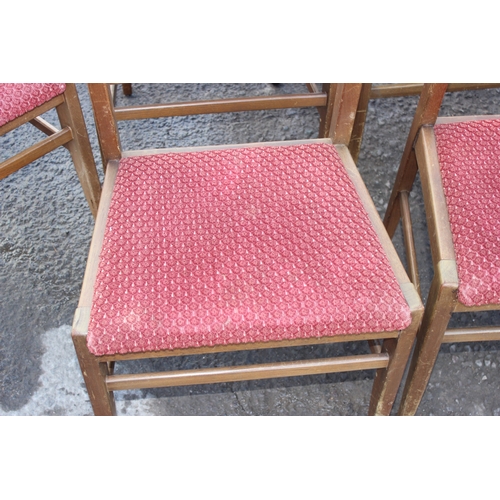 30 - A set of 6 retro dining chairs with red upholstered seats, 4 dining and 2 carver, seemingly unmarked