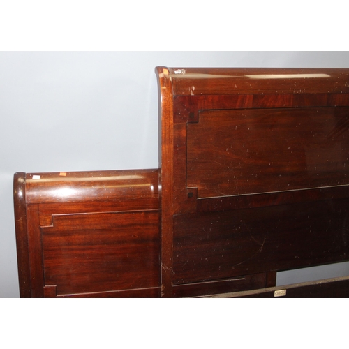 190 - An early 20th century Mahogany bed head and footboard by Heal & Son of London, with side rails but n... 