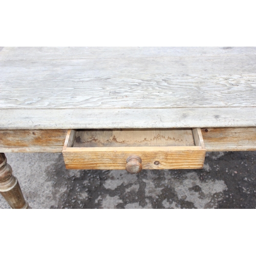 123 - A 19th century pitch pine farmhouse kitchen table with single drawer, approx 136cm wide x 85cm deep ... 