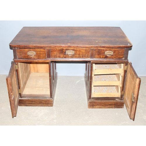 153 - An unusual early 20th century Art Nouveau/ Art Deco crossover period oak desk with brass handles, ap... 