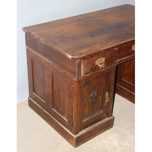 153 - An unusual early 20th century Art Nouveau/ Art Deco crossover period oak desk with brass handles, ap... 