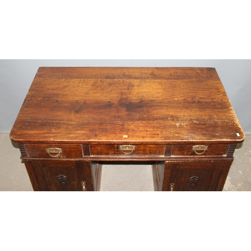 153 - An unusual early 20th century Art Nouveau/ Art Deco crossover period oak desk with brass handles, ap... 