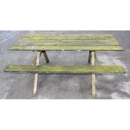 311 - A vintage weathered wooden garden picnic bench with metal frame, approx 183cm wide x 143cm deep x 72... 