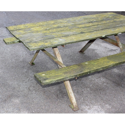 311 - A vintage weathered wooden garden picnic bench with metal frame, approx 183cm wide x 143cm deep x 72... 