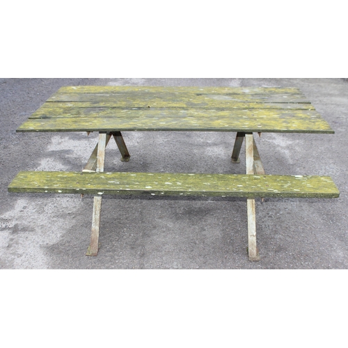 311 - A vintage weathered wooden garden picnic bench with metal frame, approx 183cm wide x 143cm deep x 72... 