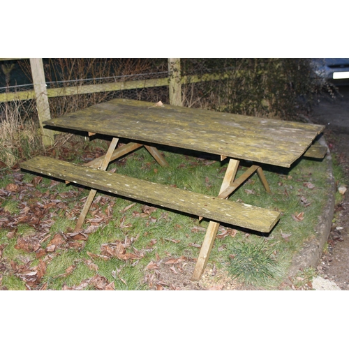 311 - A vintage weathered wooden garden picnic bench with metal frame, approx 183cm wide x 143cm deep x 72... 