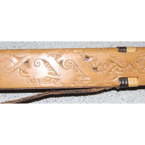 1424 - A vintage Dayak Mandau style sword with carved wooden sheath