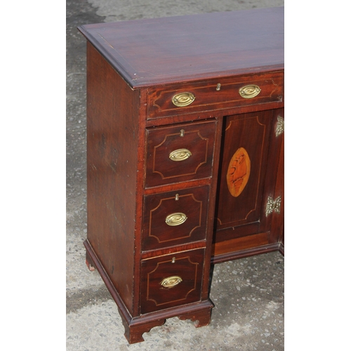 186 - A 19th century mahogany and Sheraton style satinwood inlaid kneehole desk with 8 drawers and a cupbo... 