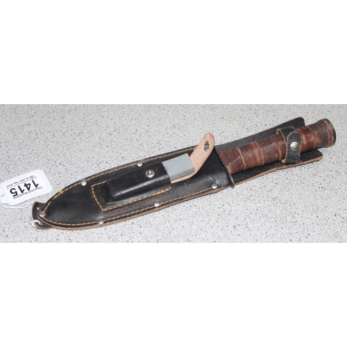 1415 - A Japanese made hunting knife with stacked leather handle, leather scabbard and sharpening stone, ap... 