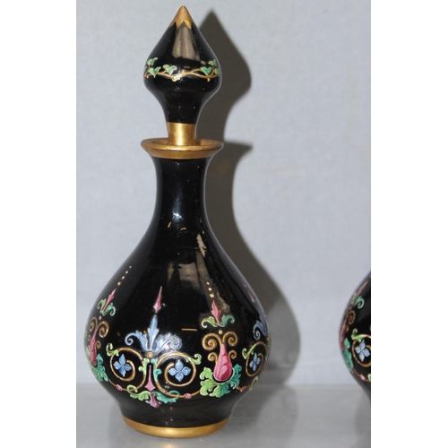 1620 - Ludwig Moser & Sons, Bohemia - two black glass and floral enamelled perfume bottles and stoppers, ea... 