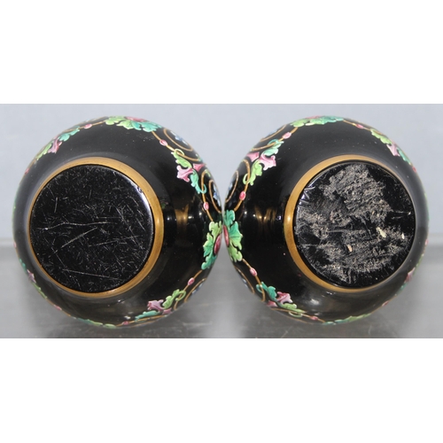 1620 - Ludwig Moser & Sons, Bohemia - two black glass and floral enamelled perfume bottles and stoppers, ea... 