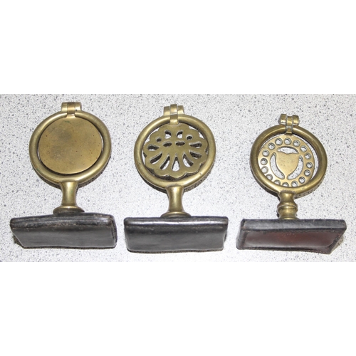 1702 - Qty of assorted antique and later horse brasses, some likely 19th century and with some leather stra... 