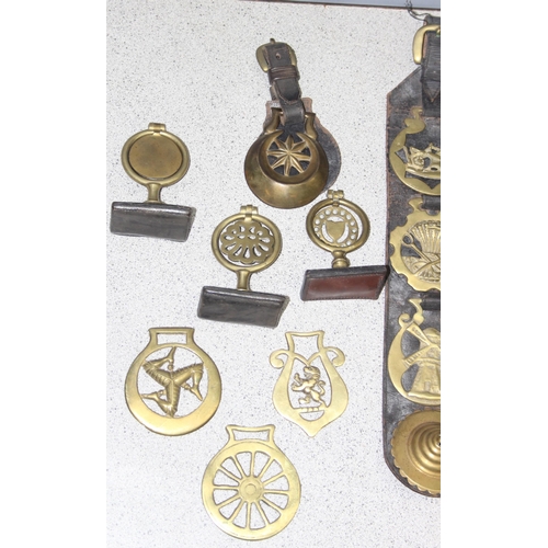 1702 - Qty of assorted antique and later horse brasses, some likely 19th century and with some leather stra... 