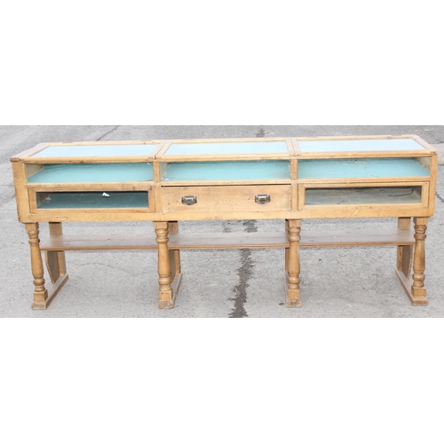 2 - An antique pine shop display counter with 3 glazed and lined compartments and a single drawer to cen... 