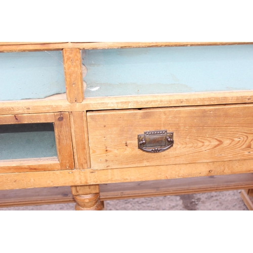 2 - An antique pine shop display counter with 3 glazed and lined compartments and a single drawer to cen... 