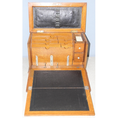 273 - A superb quality antique oak desktop stationary box, with various compartments and leather slope, ap... 