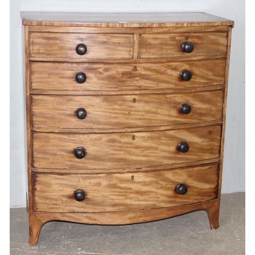 3 - A 19th century mahogany bow fronted 2 over 4 chest of drawers with turned wooden handles and bracket... 