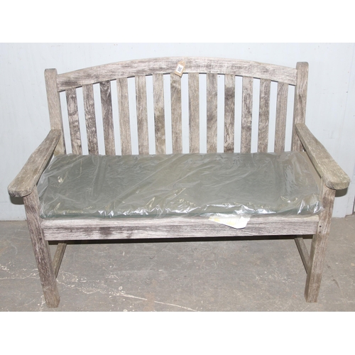 300 - Vintage weathered teak garden bench with cushion, approx 127cm wide