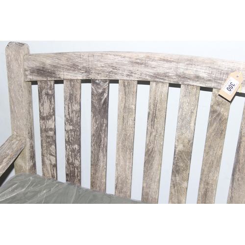 300 - Vintage weathered teak garden bench with cushion, approx 127cm wide