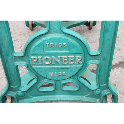 305 - A vintage green painted Pioneer brand cast iron mangle with wooden rollers, approx 102cm wide x 124c... 