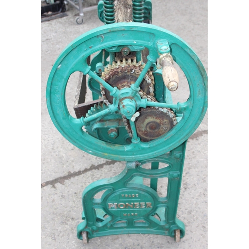 305 - A vintage green painted Pioneer brand cast iron mangle with wooden rollers, approx 102cm wide x 124c... 