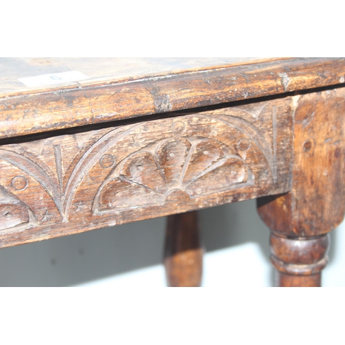 6 - An antique carved oak joint or coffin stool, 1 of 2 very similar in the sale, approx 46cm wide x 28c... 