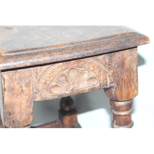 6 - An antique carved oak joint or coffin stool, 1 of 2 very similar in the sale, approx 46cm wide x 28c... 