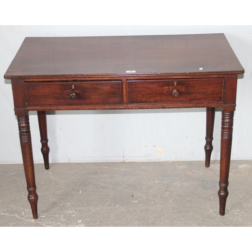 68 - A small 19th century mahogany desk with 2 drawers and turned legs, approx 101cm wide x 55cm deep x 7... 