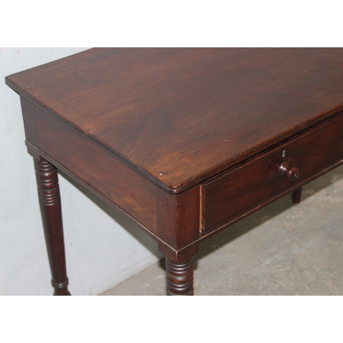 68 - A small 19th century mahogany desk with 2 drawers and turned legs, approx 101cm wide x 55cm deep x 7... 