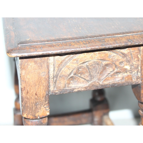 7 - An antique carved oak joint or coffin stool, 1 of 2 very similar in the sale, approx 46cm wide x 28c... 