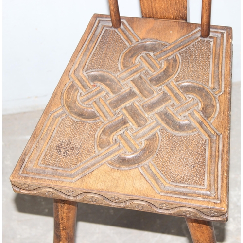 70 - Ben Setter of Totnes, a carved oak spinning chairs with Celtic designed motif, approx 24cm wide x 78... 