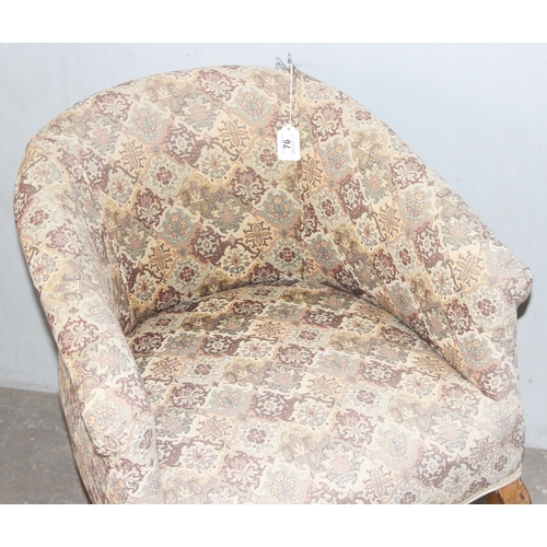 76 - A vintage upholstered tub chair with wooden legs and patterned upholstery, approx 61cm wide x 82cm t... 